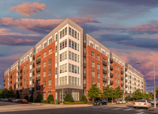 a rendering of a large apartment building on a city street