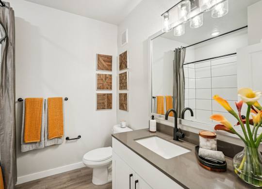 Furnished bathroom with quartz countertop in model apartment