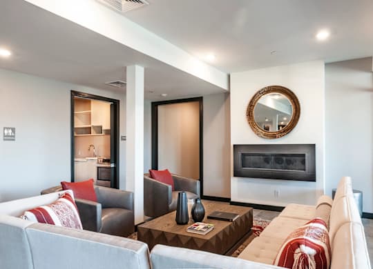 A modern living room with a fireplace and a large mirror on the wall.