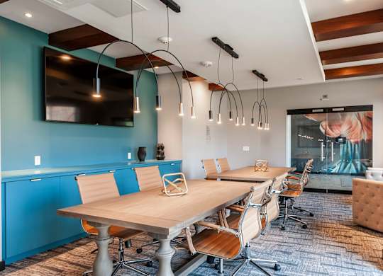 A conference room with a long table and chairs.