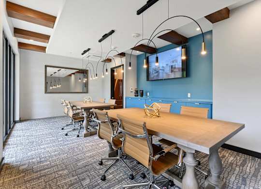 A conference room with a long table and chairs.