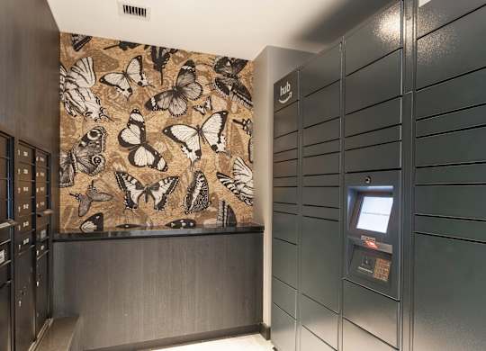 A wall with butterflies on it is behind a counter.