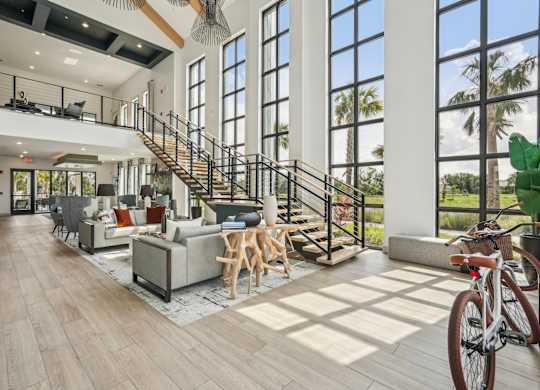 Clubhouse with furniture, stairs to the second floor, and miscellaneous decor