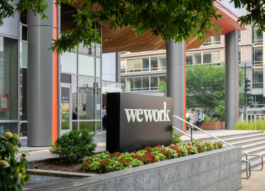a view of the wework building entrance with the we work sign