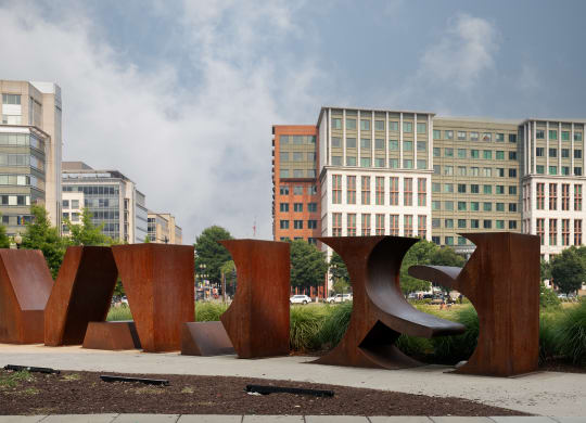 a large sculpture in front of some buildings