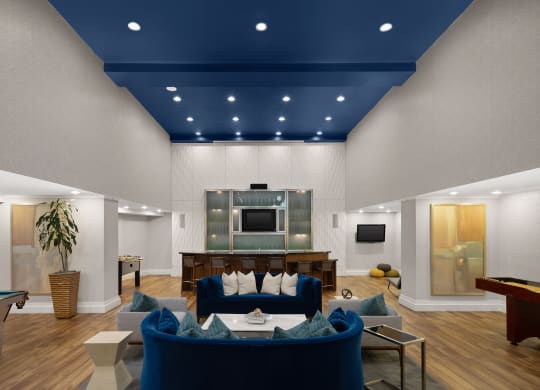 a living room with a blue ceiling and a pool table