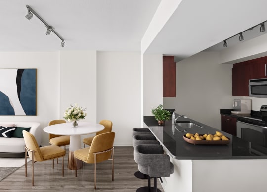 a living room and kitchen with a table and chairs