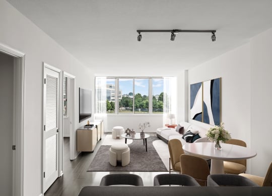 a living room with white walls and a large window