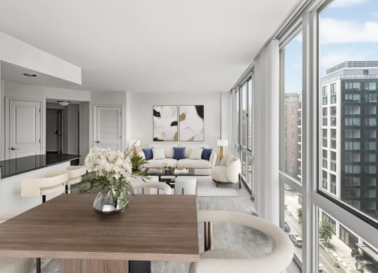 a living room with a large window and a wooden table