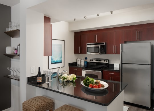 a kitchen with stainless steel appliances and a counter top with a bowl of food