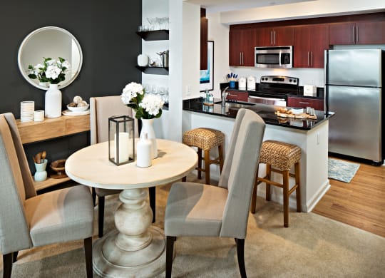 a dining room and kitchen with a table and chairs