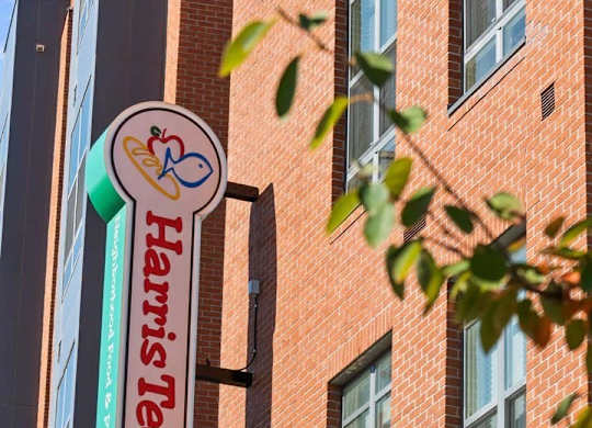 A sign for Harris Teeter hangs from a building.
