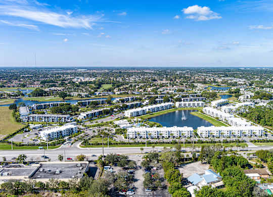 A bird's eye view of a residential area with a large lake and buildings.
