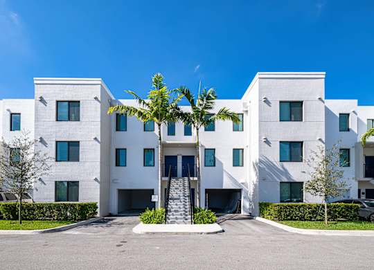 A white building with a blue sky in the background.