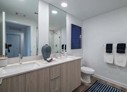 A bathroom with a white sink and a toilet.