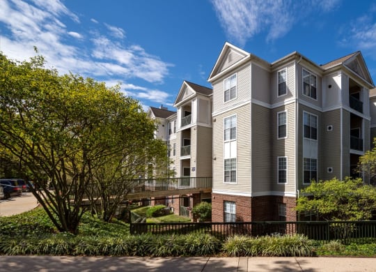 a large apartment building with trees in front of it