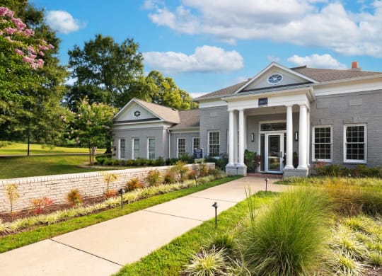 a house with a lawn and trees in front of it