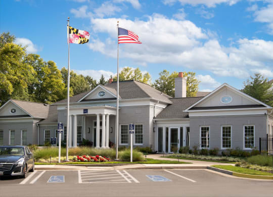 a large gray building with two flags in front of it