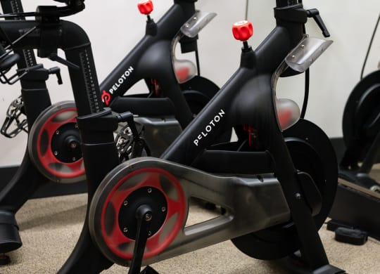a row of exercise bikes in a gym
