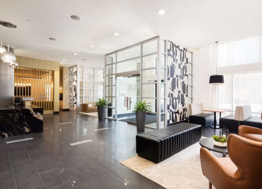 the lobby of a hotel with chairs and couches