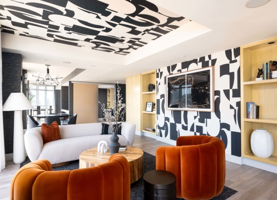 a living room with a white couch and a black and white wallpaper