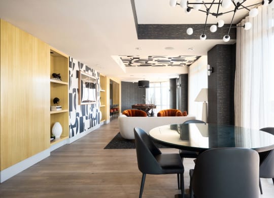 a dining room and living room with a table and chairs
