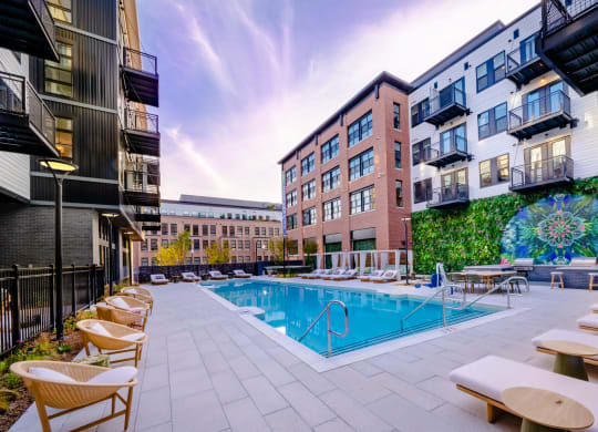 Outdoor pool with lounge chairs and dining area