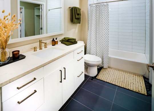Bathroom with white finishes and bathtub