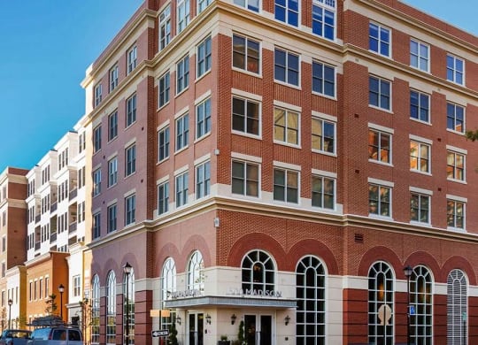 A large red brick building with white trim and arched windows.