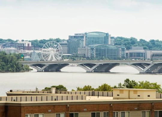 A bridge over a body of water with a building in the foreground.
