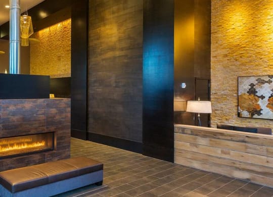A modern living room with a fireplace and a painting on the wall.