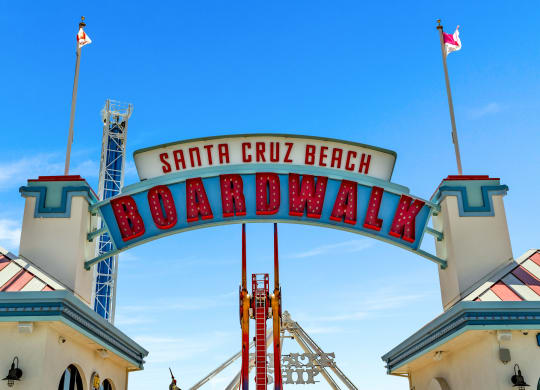 a sign for the boardwalk in front of a building