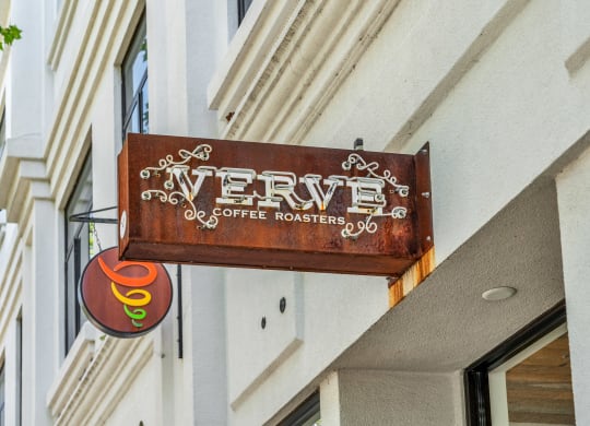 a sign for a coffee shop on the side of a building