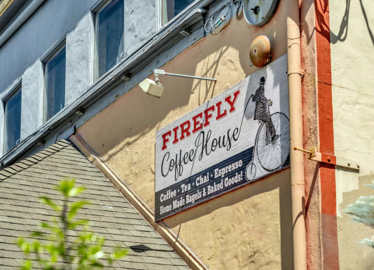 a sign for a coffee house on the side of a building