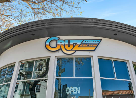 a building with a cuyo open sign on top of it