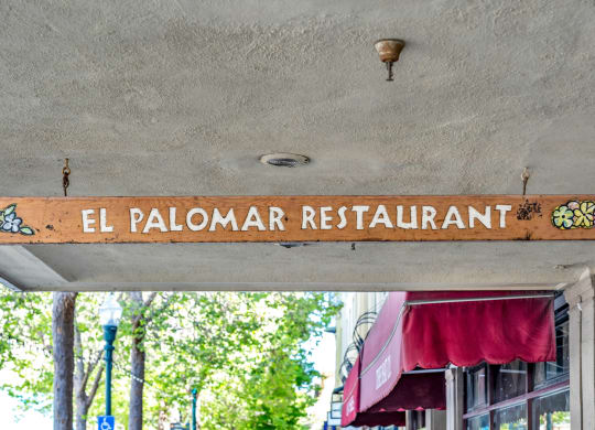 the sign for the el palomar restaurant on the front of a building
