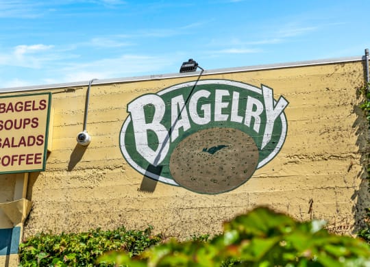 a sign for a bagel on the side of a wall