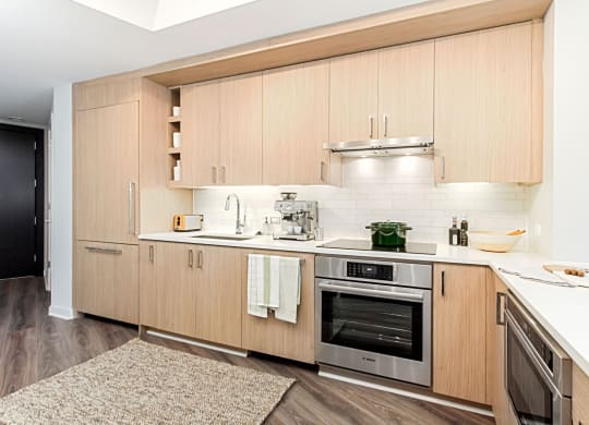 a kitchen with white countertops and wooden cabinets
