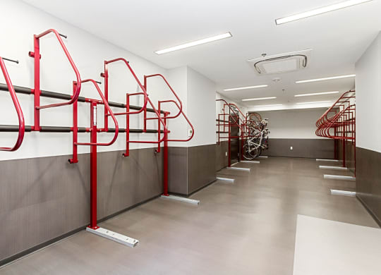 a row of red bike racks in a white walled room