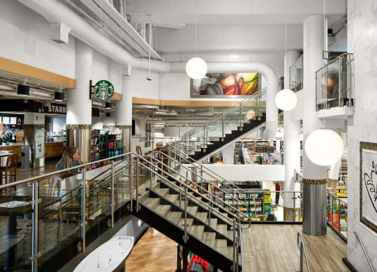 the interior of a bookstore with a staircase and bookshelves