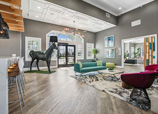 A living room with a giraffe statue in the middle.