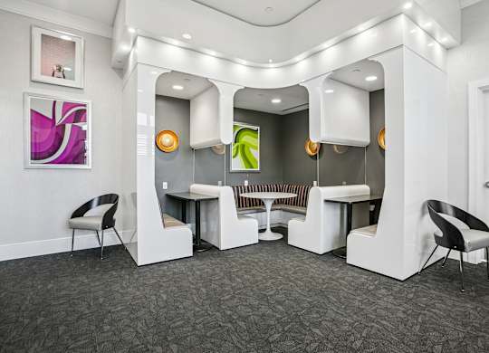 A white reception area with a grey carpet and a white chair.