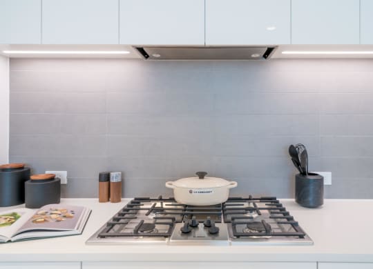 a kitchen with a stove and a pot on top of it