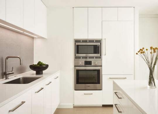 White kitchen featuring stainless steel appliances