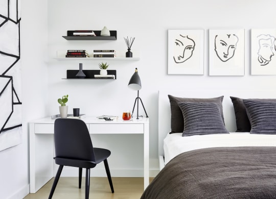 Decorated bedroom with desk and bed