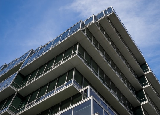 the corner of a building with a blue sky in the background