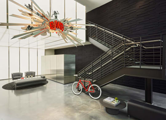 a living room with a bike and a chandelier