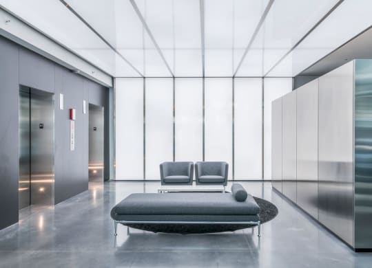 a bedroom with a bed and a couch in a lobby