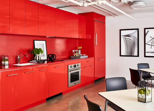 a kitchen with red cabinets and a table and chairs