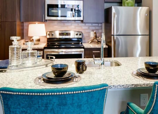 Kitchen island with seating and stainless steel appliances